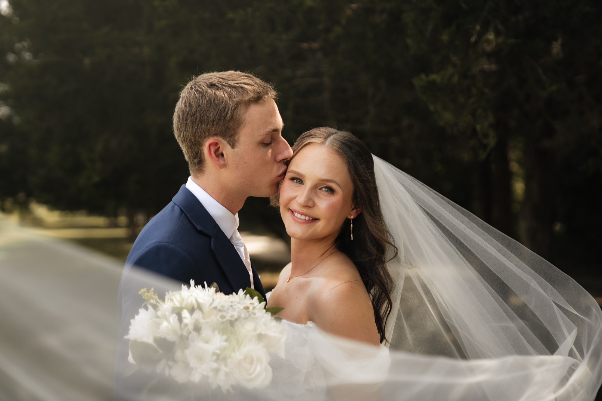 Zach kissing Katie's temple beneath her veil