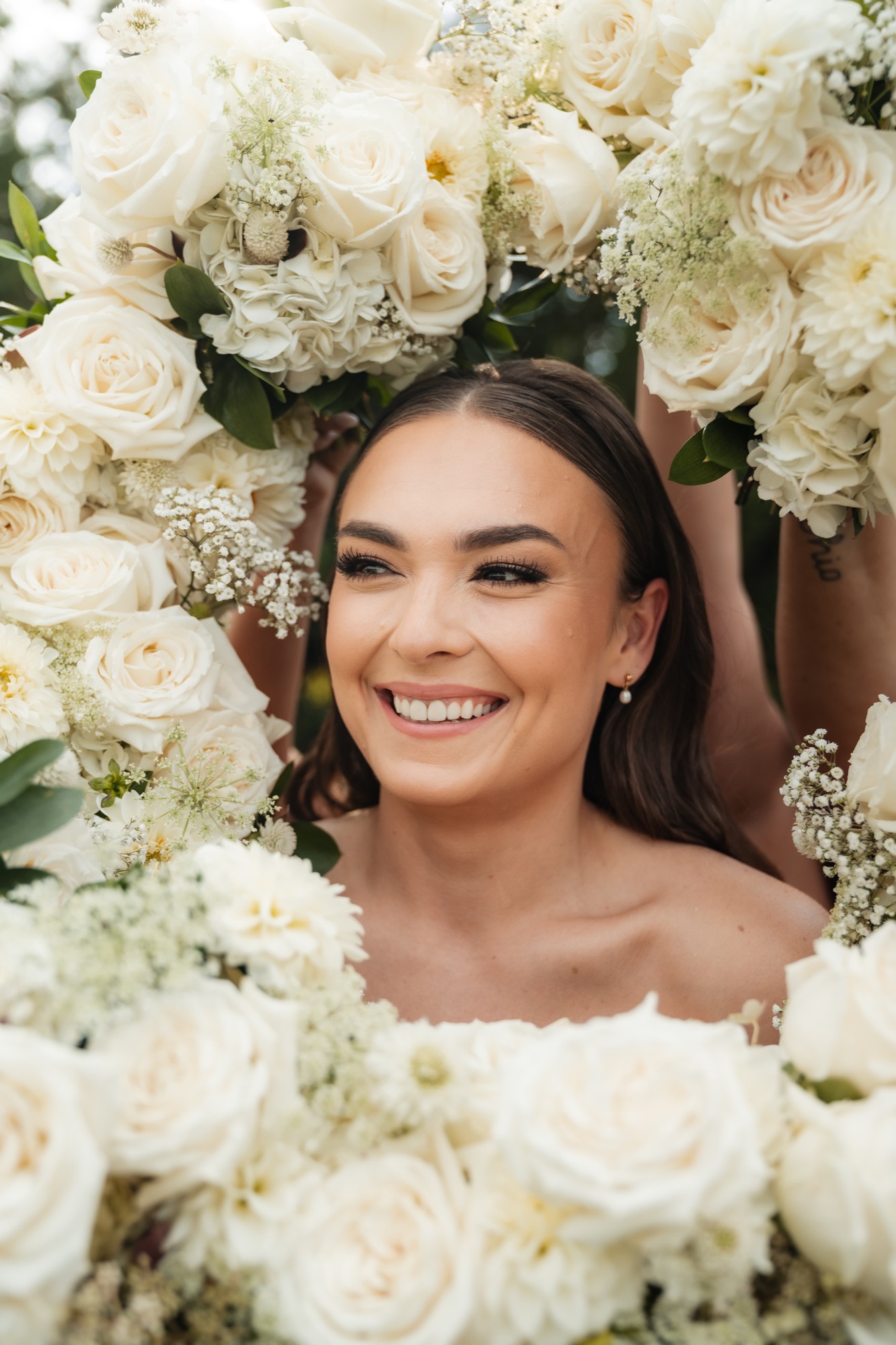 Bride framed by white wedding florals